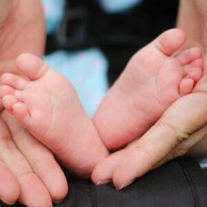 person holding baby feet